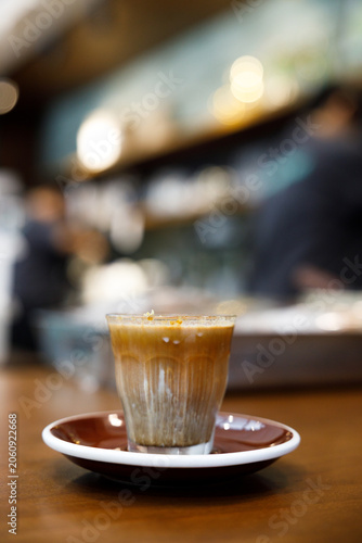 Glass of milk latte coffee on a wooden table.
