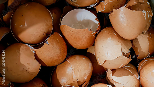 Close-up of numerous broken brown eggshells in a pile, natural calcium source and organic waste for garden compost