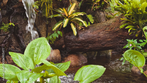 Serene waterfall cascading into a lush jungle pool surrounded by vibrant green foliage and mossy rocks, creating a tranquil natural oasis