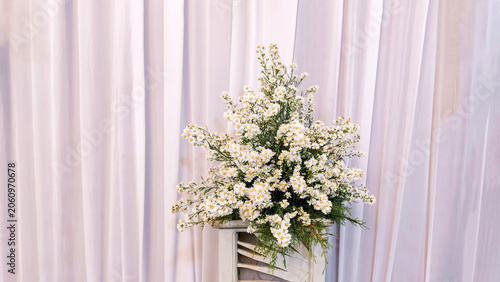 Elegant White Flower Bouquet Arrangement Displayed Against Soft Draped Fabric Backdrop for Wedding Decor