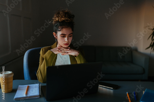 Woman working on laptop, focusing on work