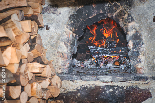 Traditional Wood-Fired Brick Oven with Burning Firewood