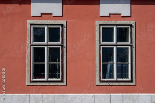 Symmetrical windows on colorful historic building facade