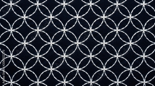 Seamless Geometric Pattern of Interlocking Circles on a Dark Background.
