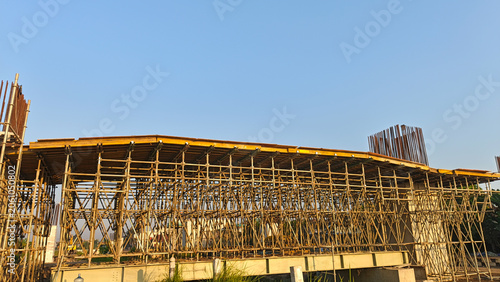 Architectural construction project with temporary steel supports and unfinished concrete structure.