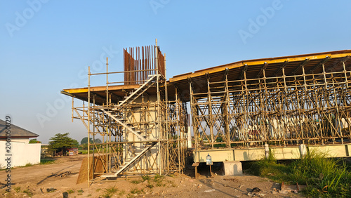 Architectural construction project with temporary steel supports and unfinished concrete structure.
