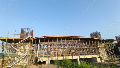 Architectural construction project with temporary steel supports and unfinished concrete structure.