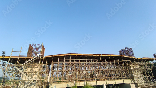 Architectural construction project with temporary steel supports and unfinished concrete structure.