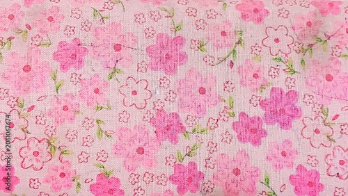 Close-Up of Pink Floral Cotton Fabric Texture with Flower Print and Green Leaf Pattern as Textile Background