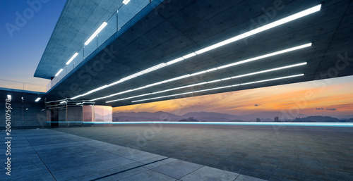 3d rendering modern futuristic architecture with empty concrete floor at sunset