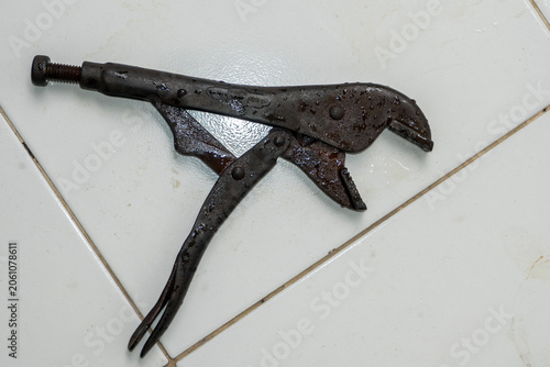 Old, rusty locking pliers, used during bathroom equipment repairs