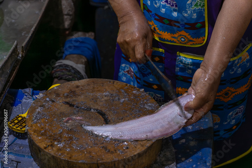 Fishmonger Preparing Fresh Sole Fish on Cutting Board
