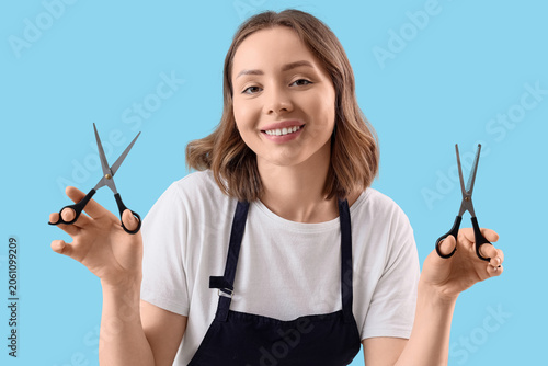 Smiling female hairdresser ...