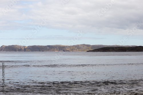 Konstfotografi Calm seascape with rocky coastline and cloudy sky
