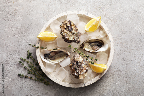 Fresh raw oysters on ice wi...