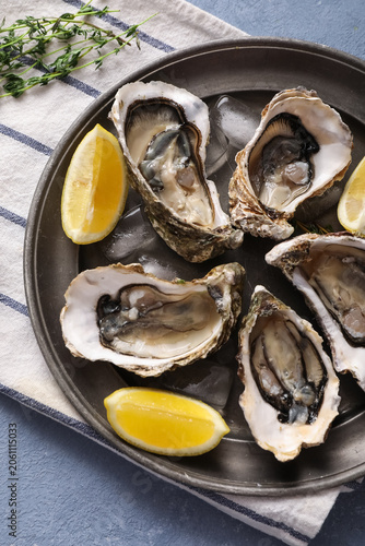 Fresh raw oysters on ice wi...