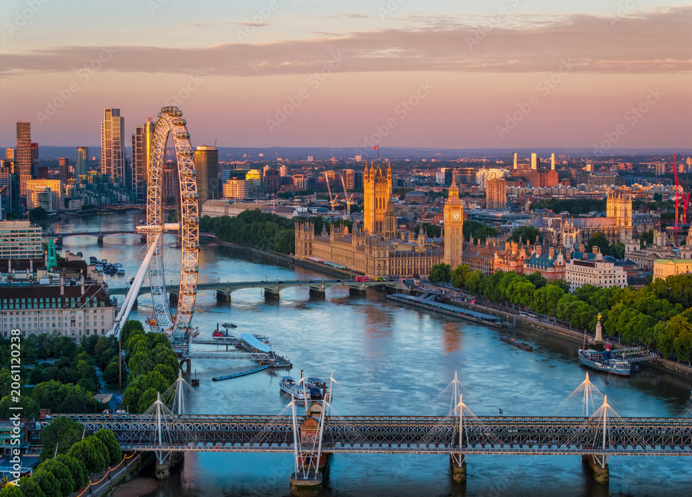 Obraz premium Aerial view of the skyline of London, England, with Southbank and Embankment, Westminster Palace during a golden summer sunrise