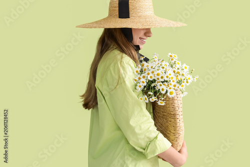Young woman holding wicker ...