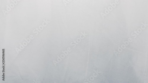 white linen fabric ripples gently under soft natural studio lighting in a serene cinematic tracking shot