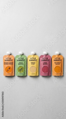 Five vibrant pouches of organic baby food are neatly arranged against a neutral backdrop. Each pouch offers a unique flavor, promoting healthy nutrition for little ones, filled with goodness.