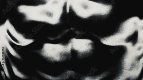 grainy textured liquid morphs slowly in a surreal monochromatic abstract visual loop