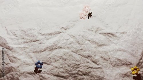 embroidered linen fabric texture reveals delicate floral details in gentle macro panning cinematic view