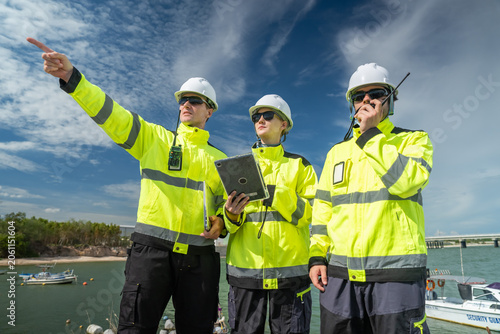 Safety inspection lng facility group of workers industrial site outdoor teamwork and compliance