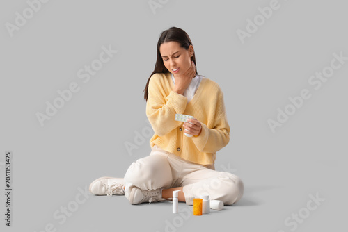 Young woman with pills and ...