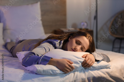 Young woman sleeping in bed...