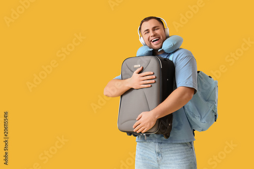Young happy man with suitca...