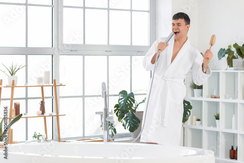 Young man with shower head ...