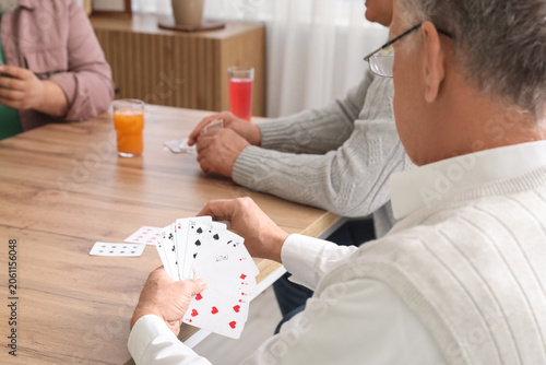 Elderly men with drinks pla...