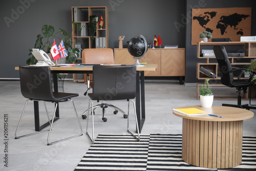 Interior of travel agency with table and flags
