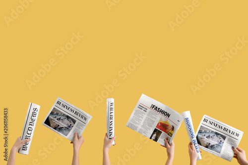 Women with newspapers on ye...