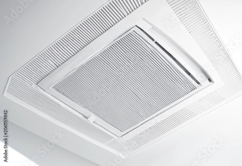 Modern ceiling air conditioning unit with white filter grid showcasing HVAC ventilation system, indoor climate control, clean design, and energy efficient residential and commercial installation.