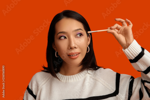 Young Asian woman with make...
