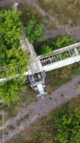 Aerial look down on weathered An-2 Antonov airplane abandoned in old airfield, aviation remains in greens