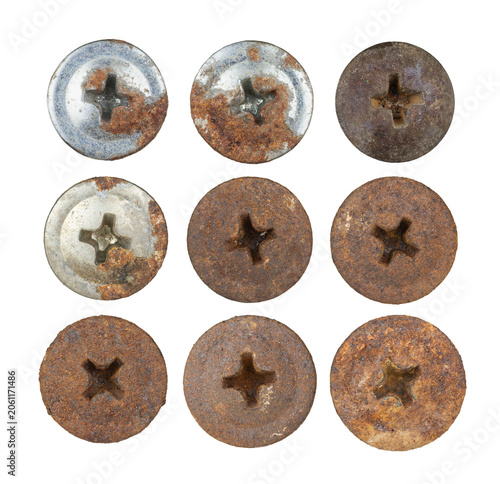 Nine rusty metal screw heads isolated on white background
