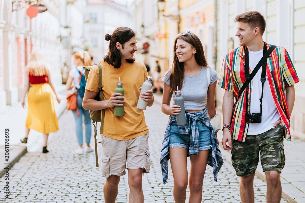 Fototapeta premium Young tourists sightseeing on charming European street