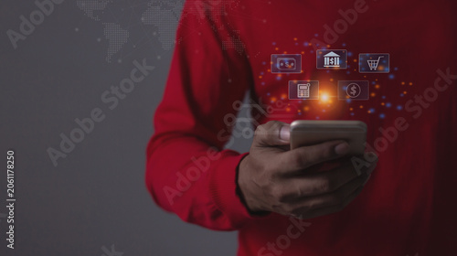 Young man with smartphone hand touching to visualize money growth The phone screen displays graphs and charts showing increasing investment and savings trends, along with an increased account balance