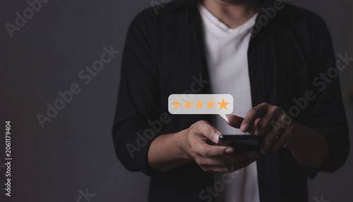 Customer Review, Young Man hand holding Smart Phone with five star to review and give 5 stars with very good results in service, Good review 5 star rating choice feedback