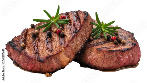Photos Two grilled beef steaks with rosemary and peppercorns