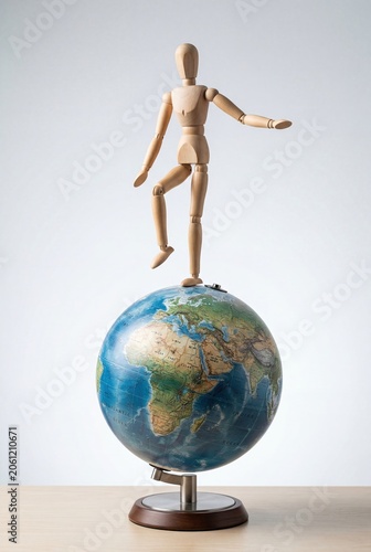 Global balance concept with wooden figure on earth globe