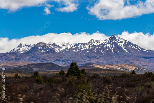 Snow‑Capped Mountain Range Above Dry Grasslands