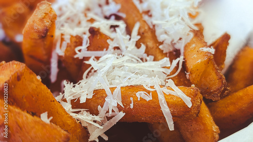 close up of sweet potato fries with grated parmesan cheese