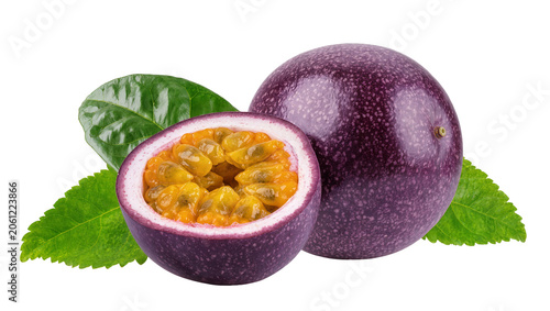 Whole and halved passion fruit with green leaves
