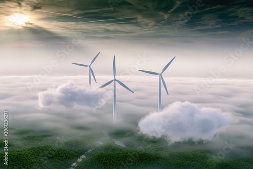 Wind Turbines Above Misty Green Landscape With Dramatic Sunlight