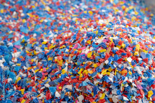 Fotografie Plastic colorful pieces recycling shredded for industrial use.
