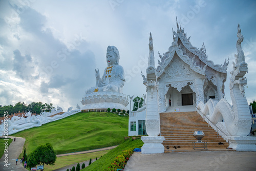Εκτύπωση καμβά Giant white Guan Yin statue sitting on a lotus pedestal on green hill under beautiful blue sky at Wat Huay Pla Kang, Chiang Rai, Thailand
