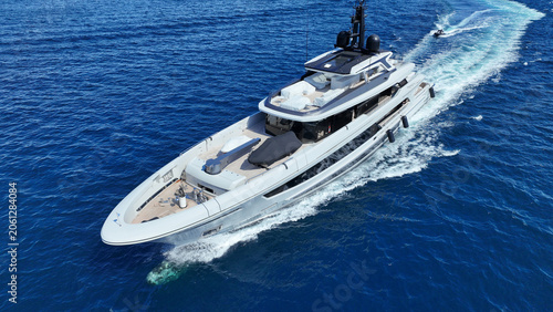 Aerial drone photo of luxury yacht cruising in deep blue open ocean Aegean Sea